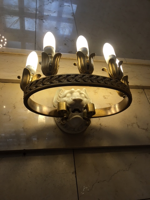 light fixture featuring lion carving