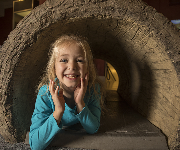 child in a tunnel in Discovery Basecamp