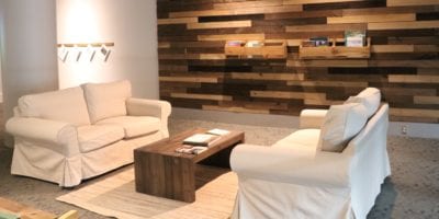two white loveseats with coffee table between