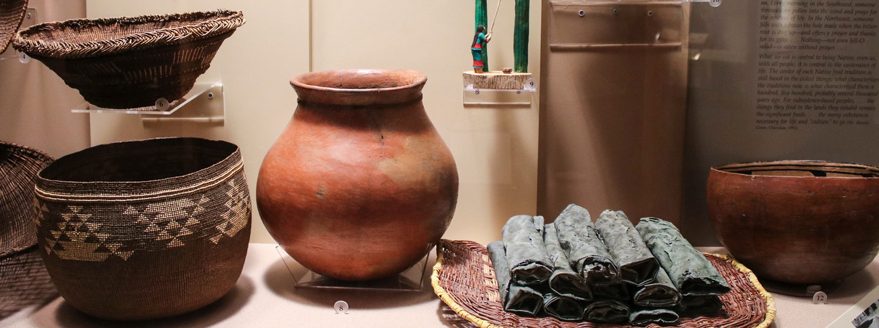 Collection of clay pots and woven baskets representing the section of anthropology