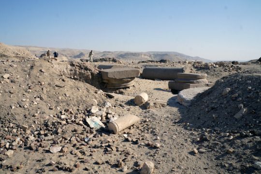 Ancient Egyptian column shafts partially uncovered in an archeology dig