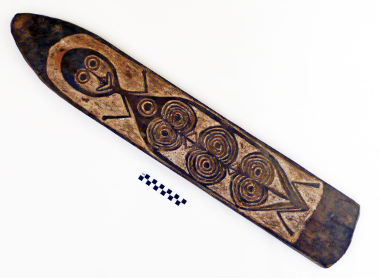 Carved wooden board from Morigio Island depicting a human-like figure