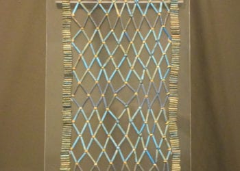 Decorative collar of beads in a diamond shaped blue and yellow pattern
