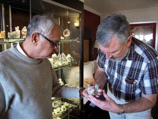 two men looking at a mineral together