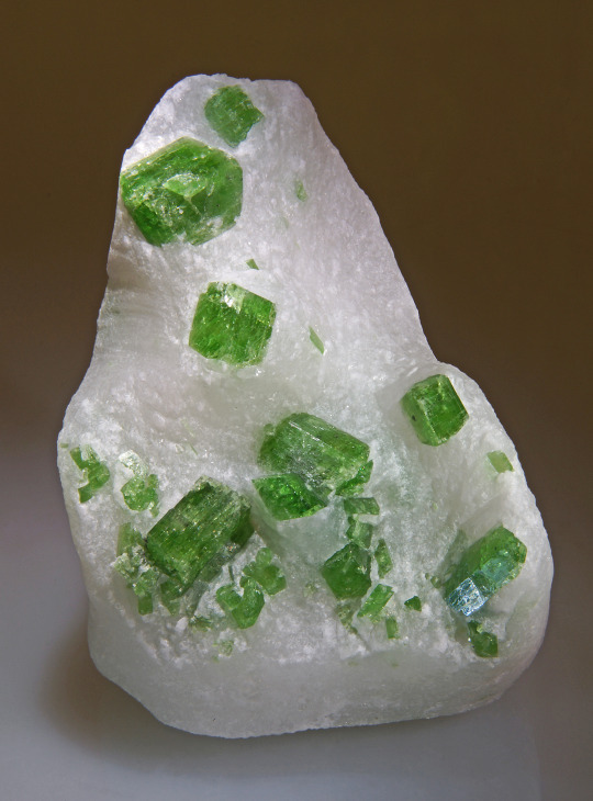 A white peice of marble with green pargasite 