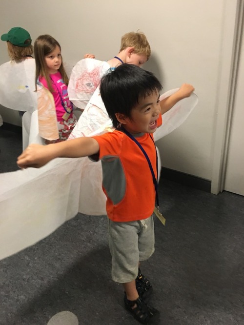 campers "flying" with paper wings