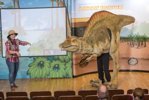 spinosaurus puppet performing in a show 