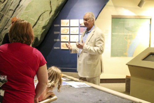 Albert talking to visitors in Benedum Hall of Geology