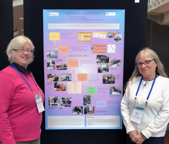 two researchers and their poster