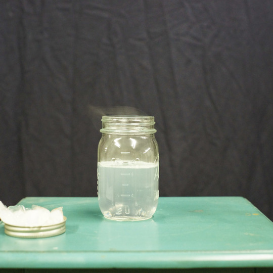 mason jar filled with water beside mason jar lid with ice