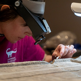 a conservator works on an ancient tablet