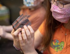 girl looking at mineral