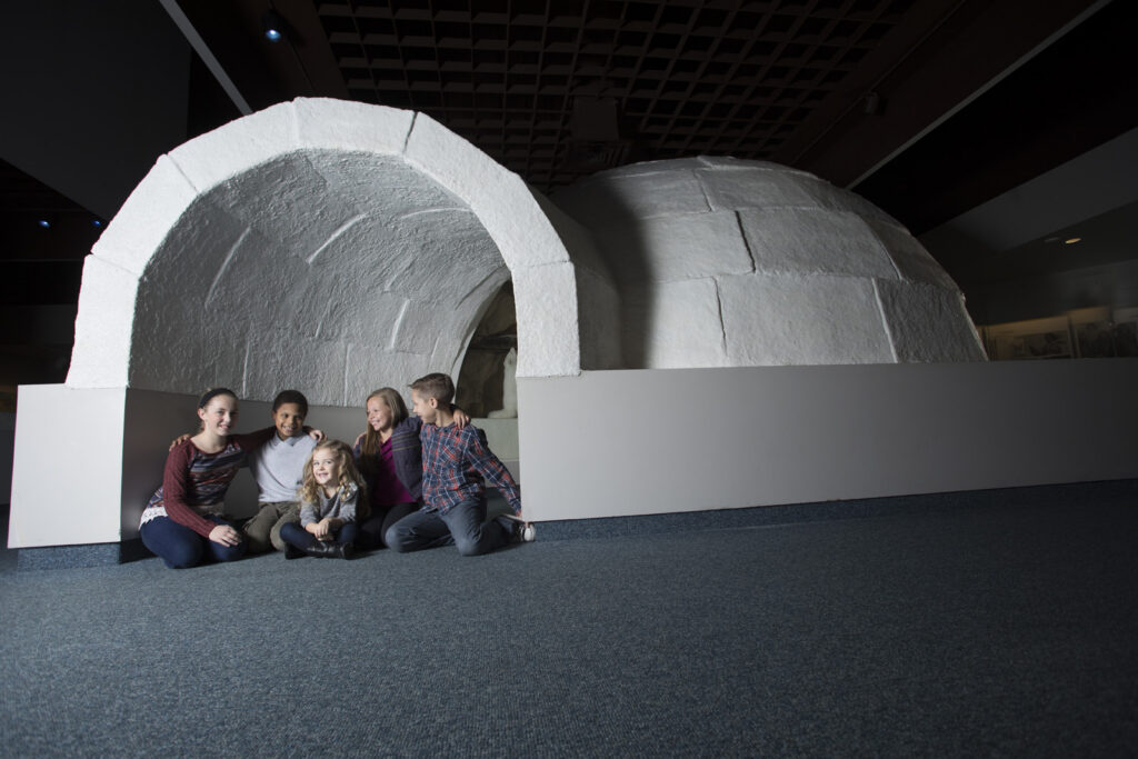kids in a reconstructed snowhouse