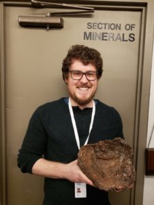 Travis Olds holding a mineral