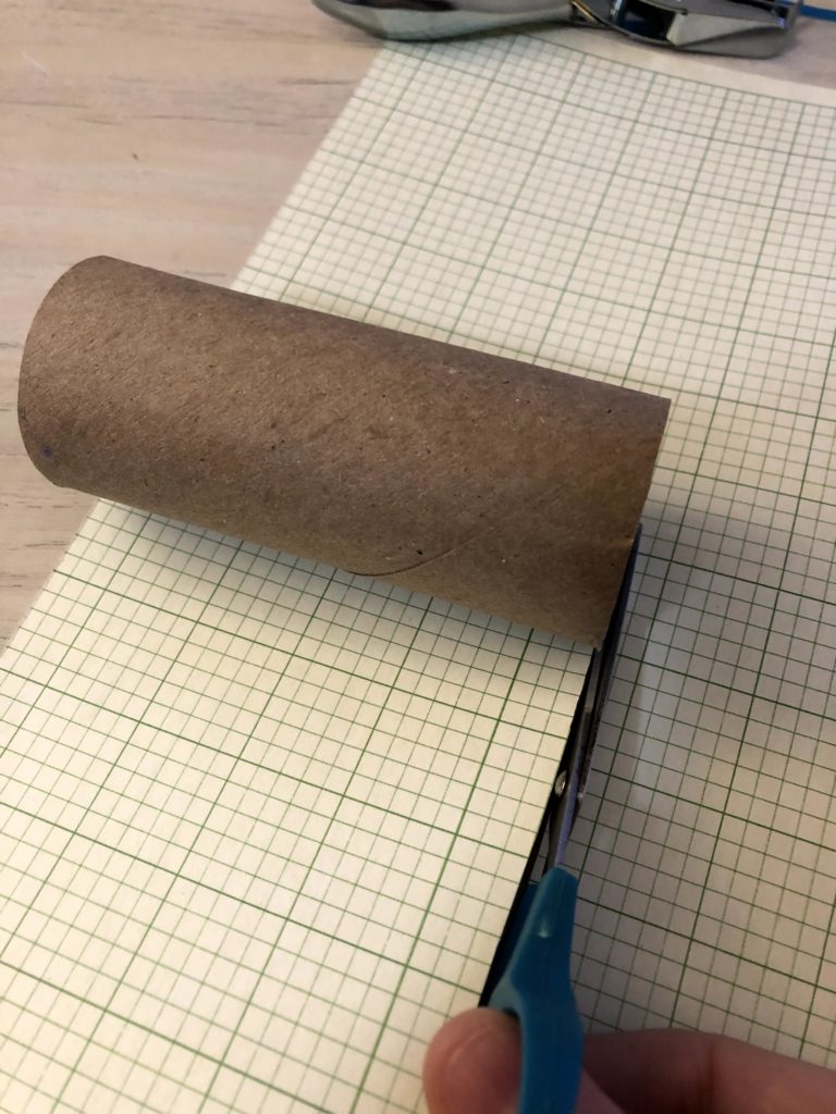 cutting paper to cover toilet paper tubes
