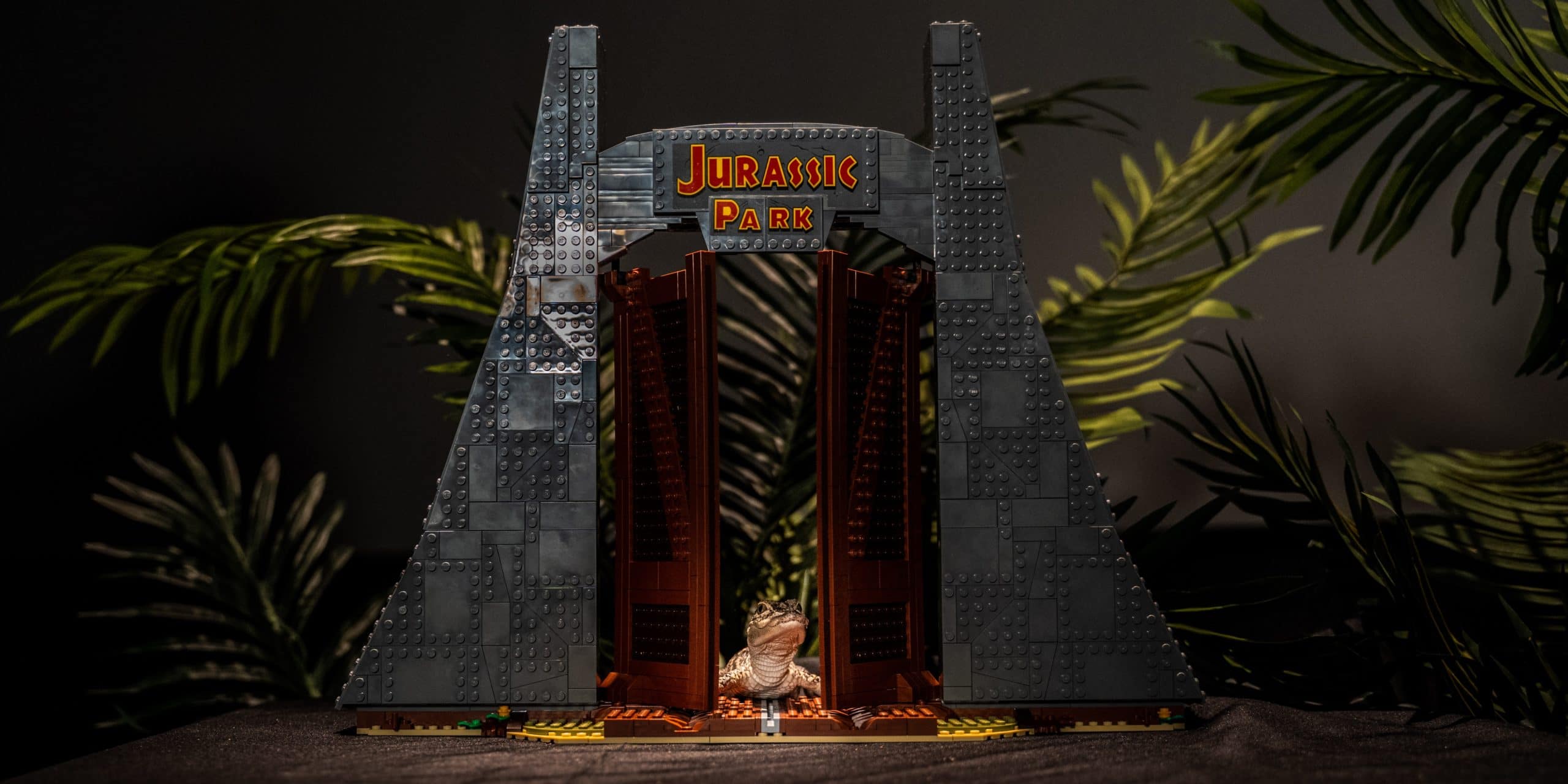 baby alligator in front of lego jurassic park sign