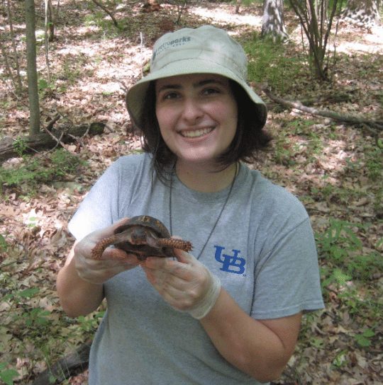 photo of woman holding a turtle