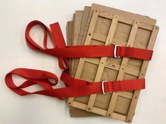 cardboard, wooden boards, and red cam straps