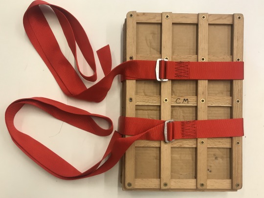 stack of boards secured with red straps
