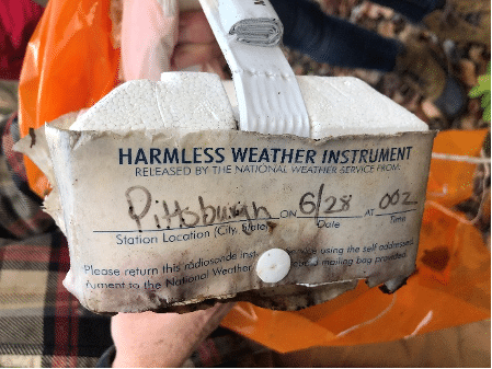 close up of weather balloon label that says "Harmless Weather Instrument"