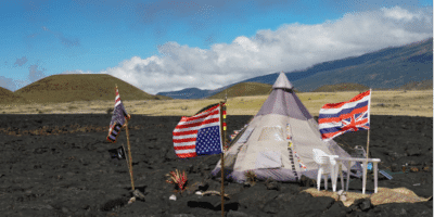 tent surrounded by upside-down flags