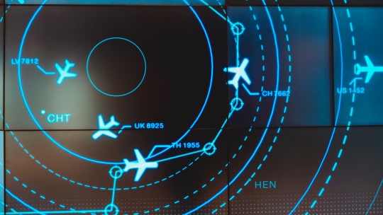 air traffic control radar with blue circles and airplanes on black background
