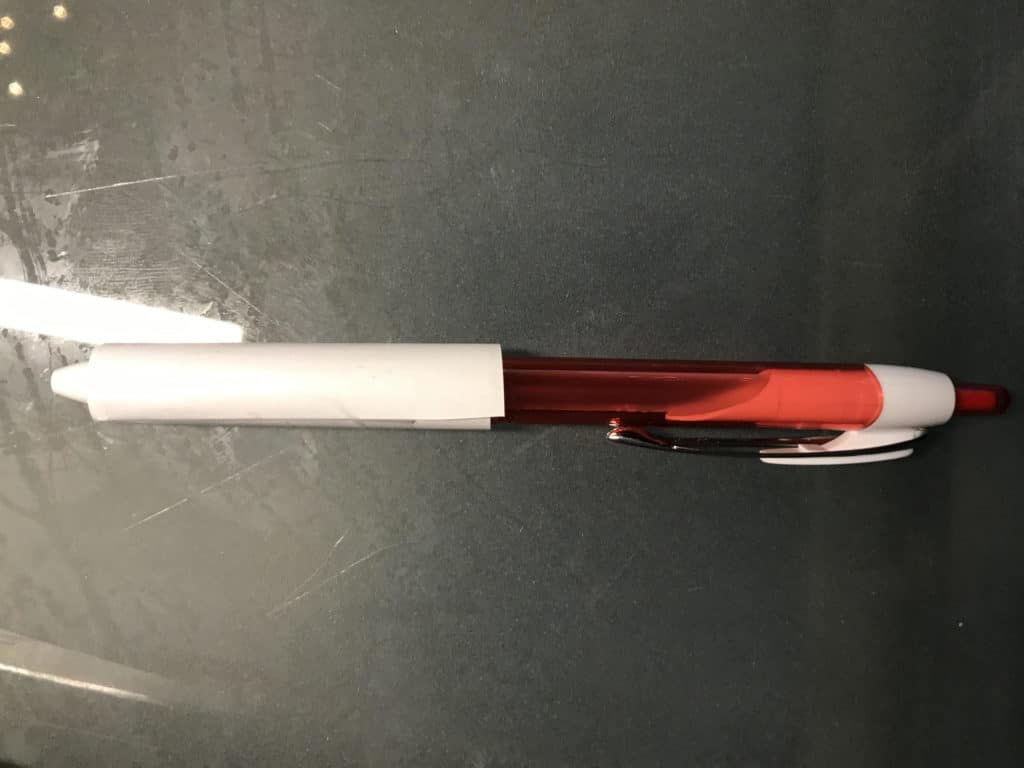paper rocket on the tip of a pen
