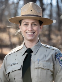 Allegheny County Park Ranger Elise Cupps in khaki shirt with black tie and tan hat