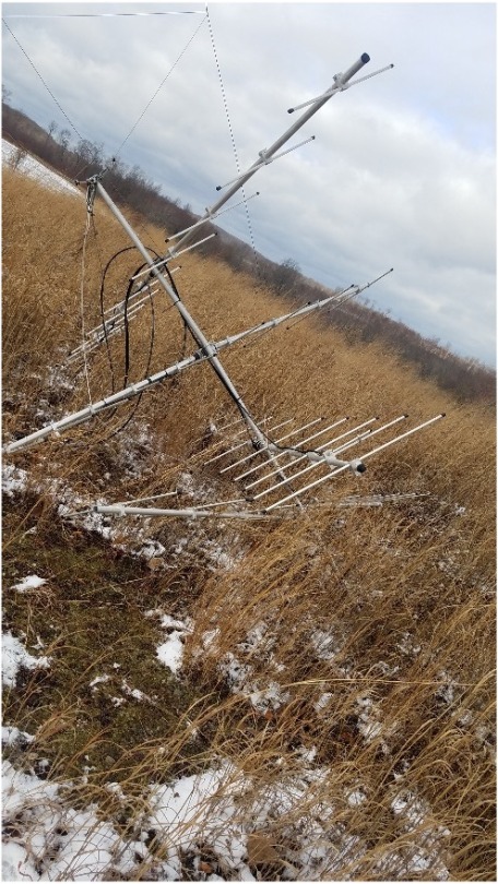 fallen Motus tower in a field with snow
