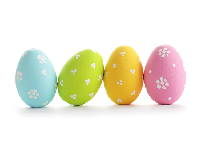 four painted eggs on a white background