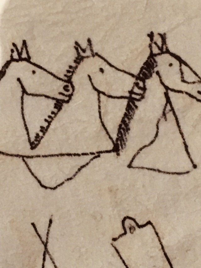 close up of winter count showing animals drawn in black on off-white background