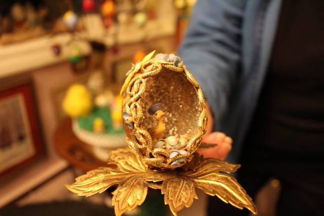 decorative gold egg with bird figurine