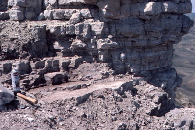 Rocky landscape with tools set out on the left side of the image. 