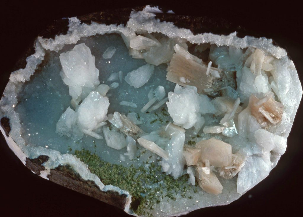 mineral specimen with white, pastel blue, pale pink, and mossy green coloration