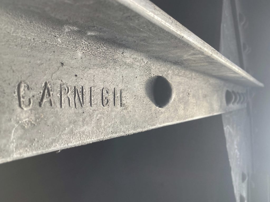 Close-up of a steel bar with the name Carnegie on it. 