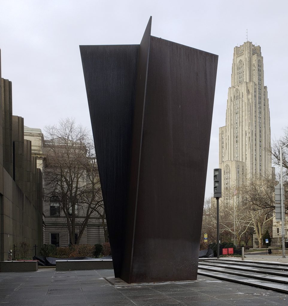 Richard Serra's Carnegie sculpture with the Cathedral of Learning framed in the background.