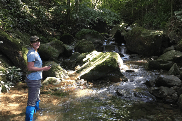 Jen Sheridan stands in a stream in Borneo