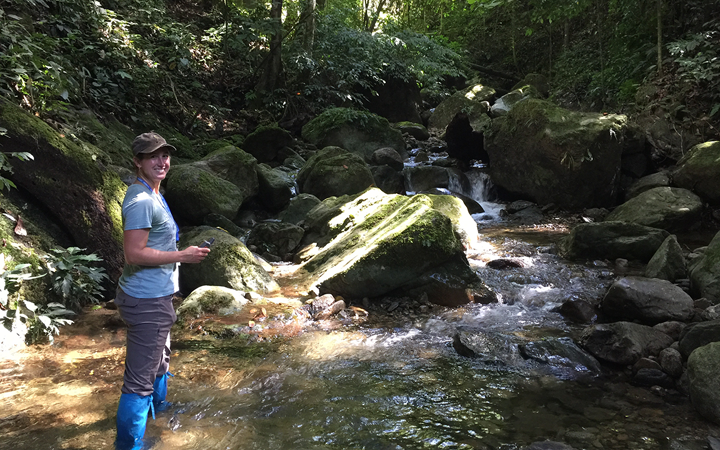 Jen Sheridan stands in a stream in Borneo