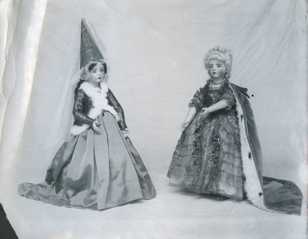 black and white photo of two character dolls