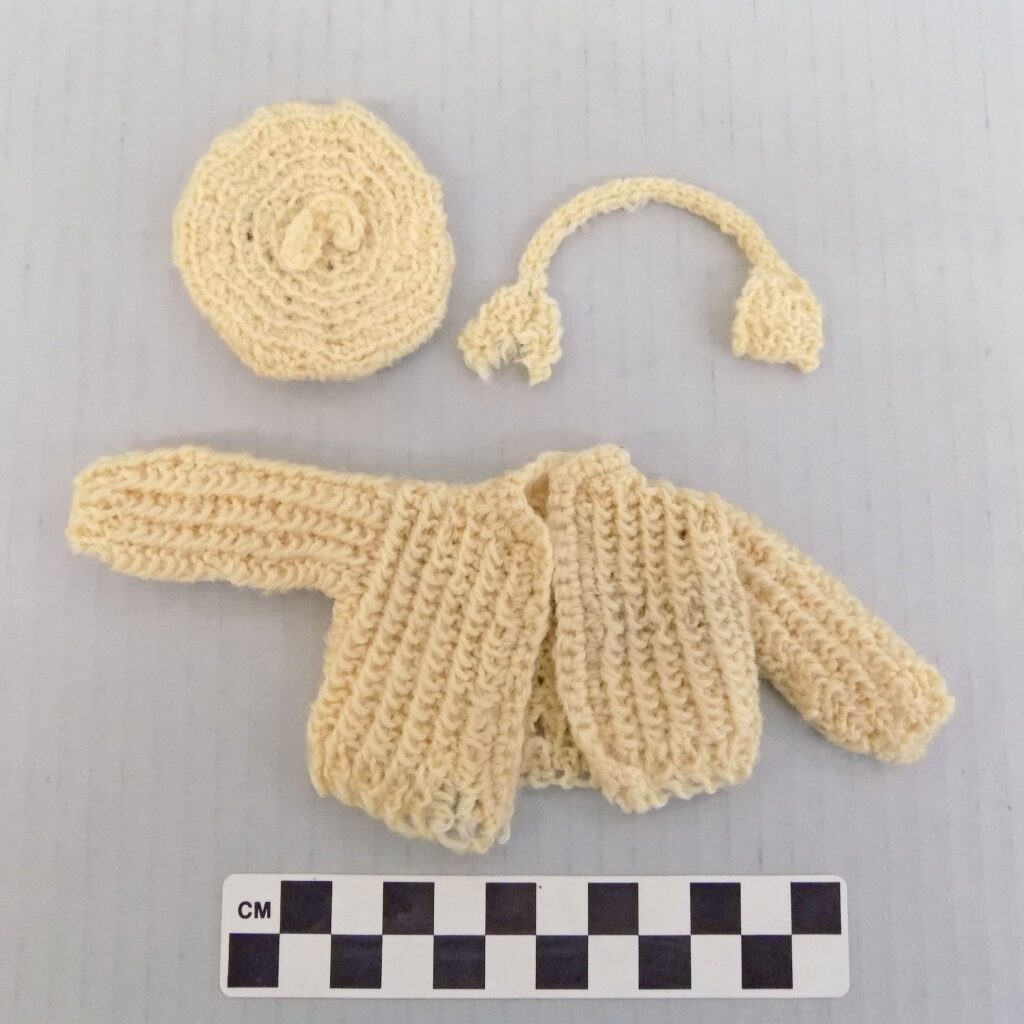 White hat, earmuffs, and sweater for a Barbie doll
