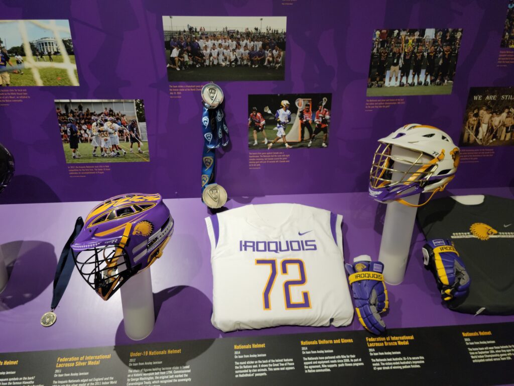 Jersey, helmets, photos, and more in a display about the Haudenosaunee Nationals. 