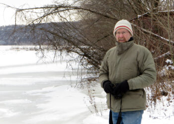 Pat McShea standing next to an icy river