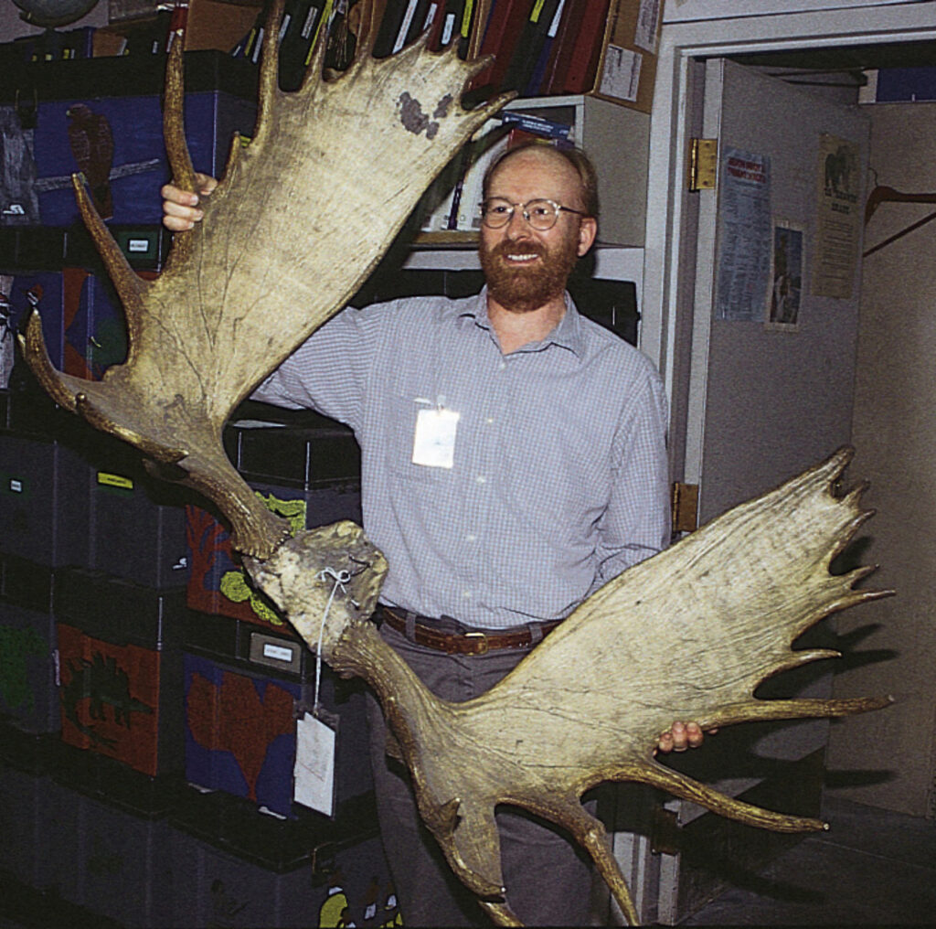 Pat McShea holding large antlers