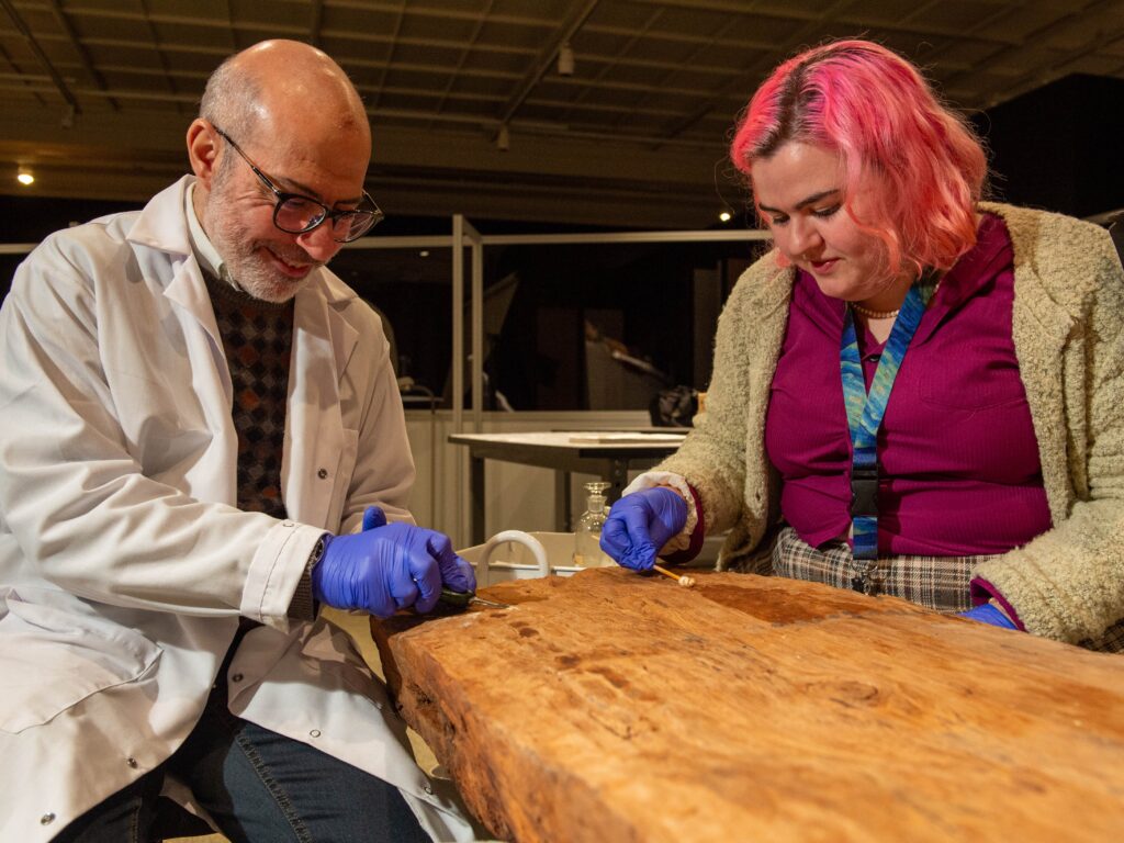 conservators cleaning ancient egyptian wood with q-tips