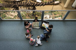 group of small children sitting in circle with a teacher