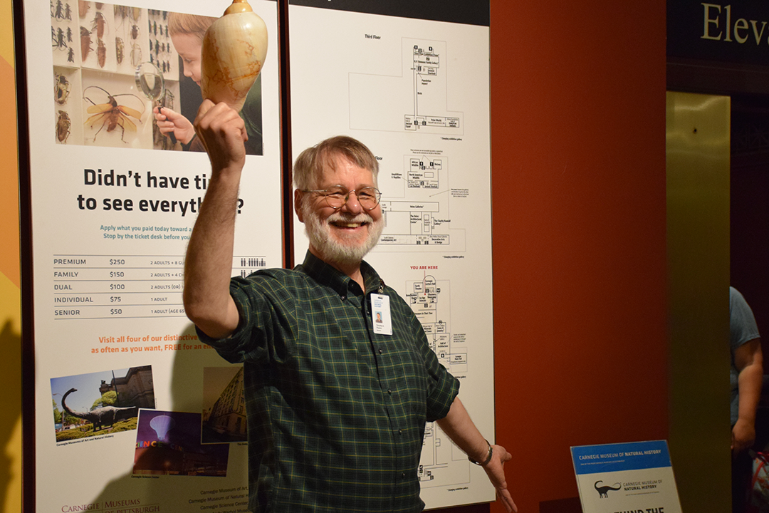 Tim Pearce holding a mollusk shell