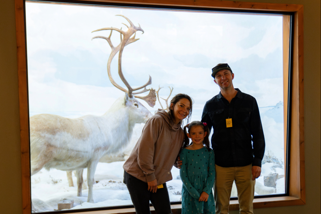 family in front of a wintry diorama