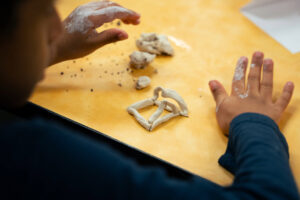 kid working with clay