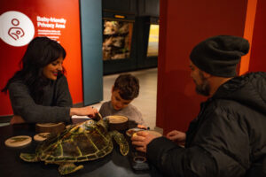 family playing with a nature toy