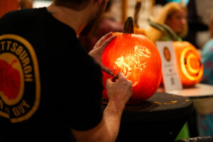 a person carving a pumpkin